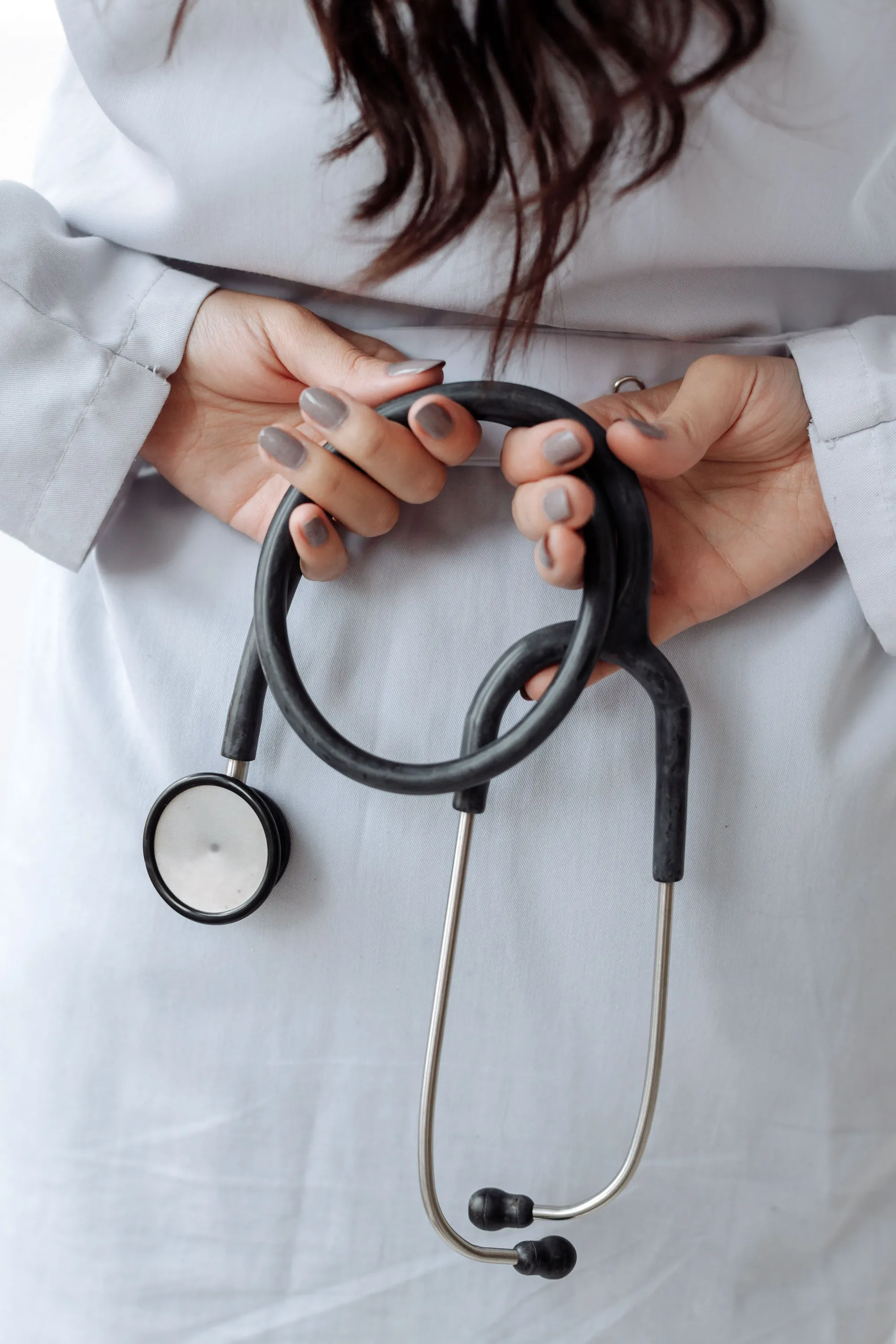 A doctor in a white coat holding a stethoscope